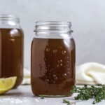 Two jars of vegetable broth standing next to each other.