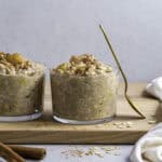 Two clear cups filled with overnight oats, topped with cinnamon.