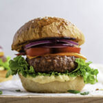 Beyond burger on a wooden cutting board layered with white parchment paper.