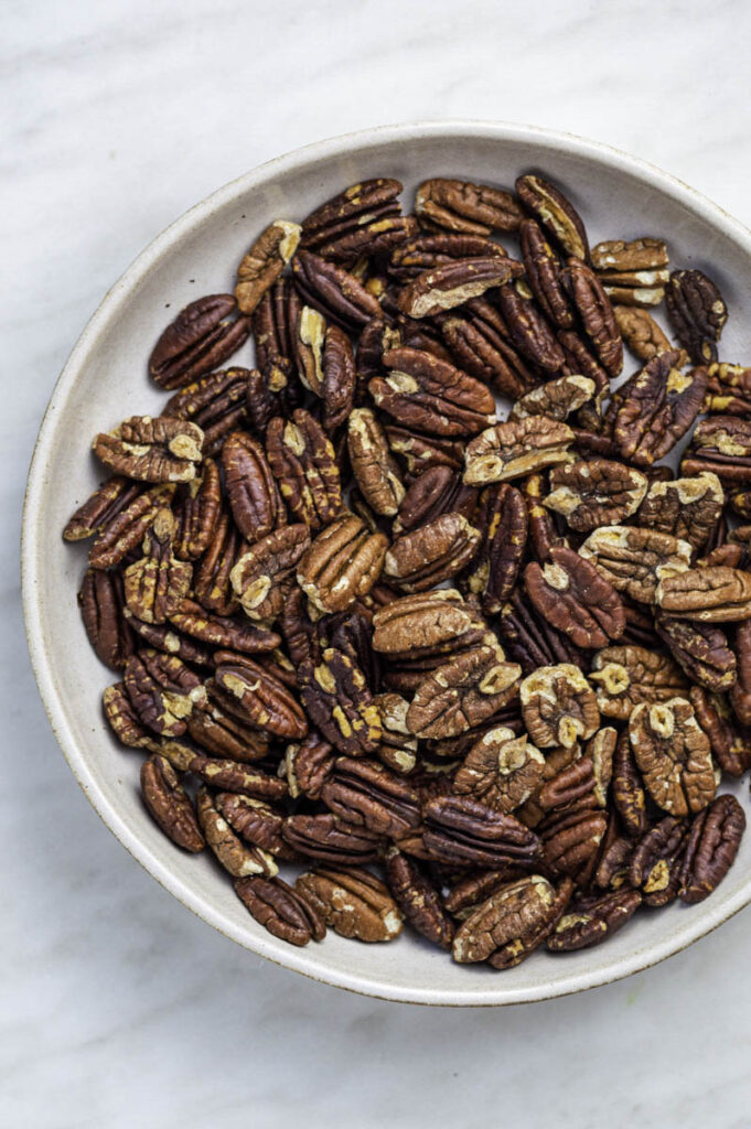 Pecans cooling in a white plate.