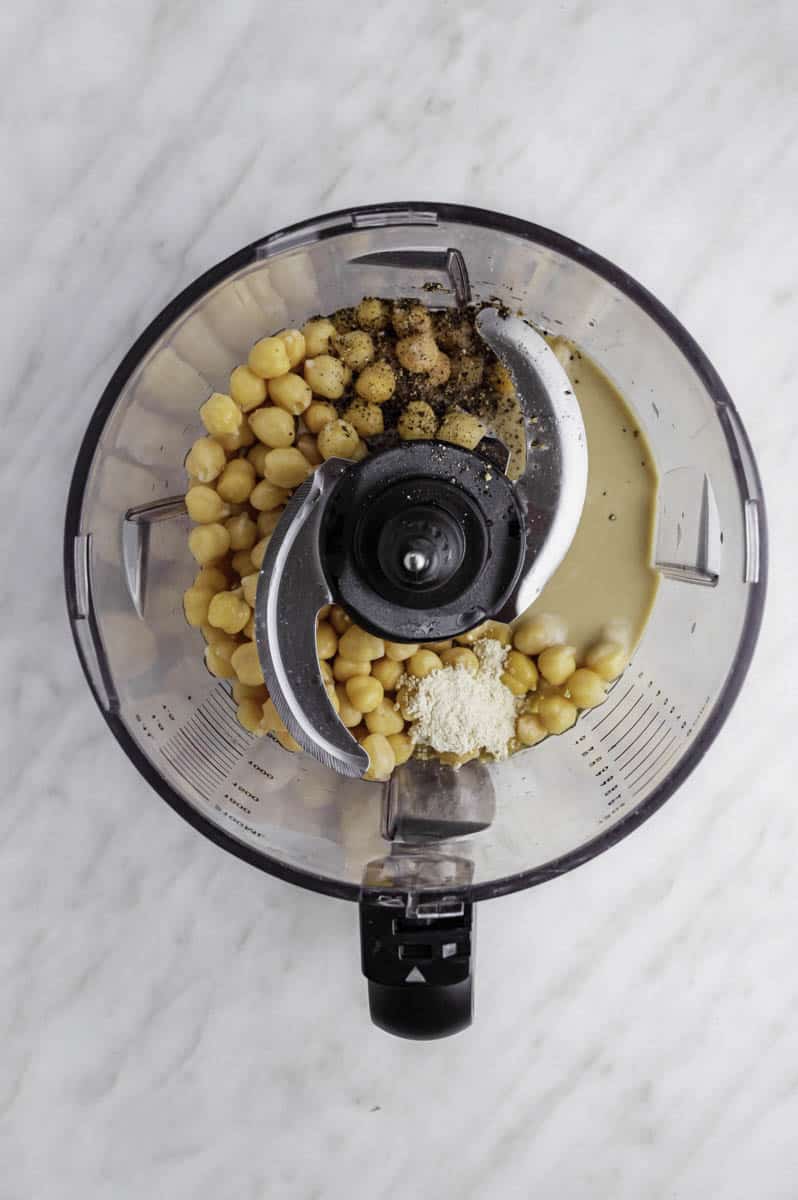 Chickpeas, tahini, olive oil, lemon juice, and spices in a food processor.