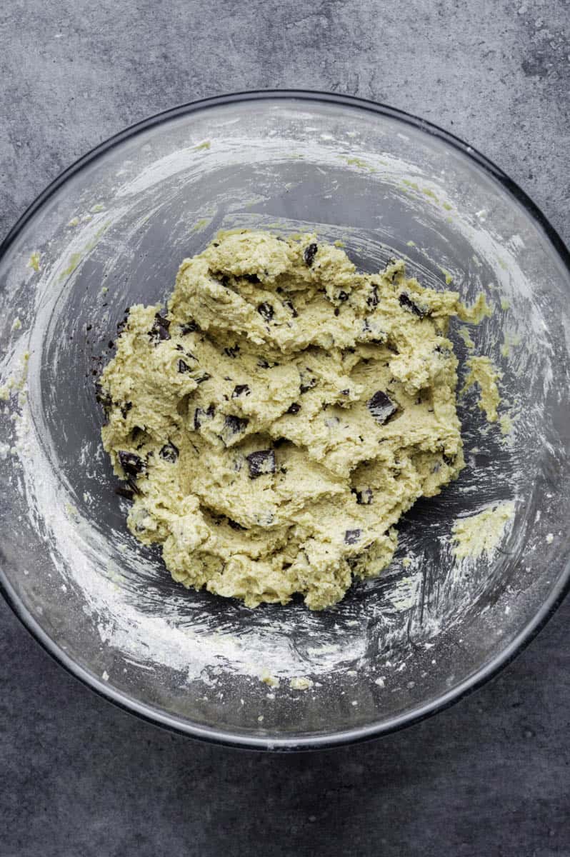 Edible cookied dough with chocolate chips in a large mixing bowl.