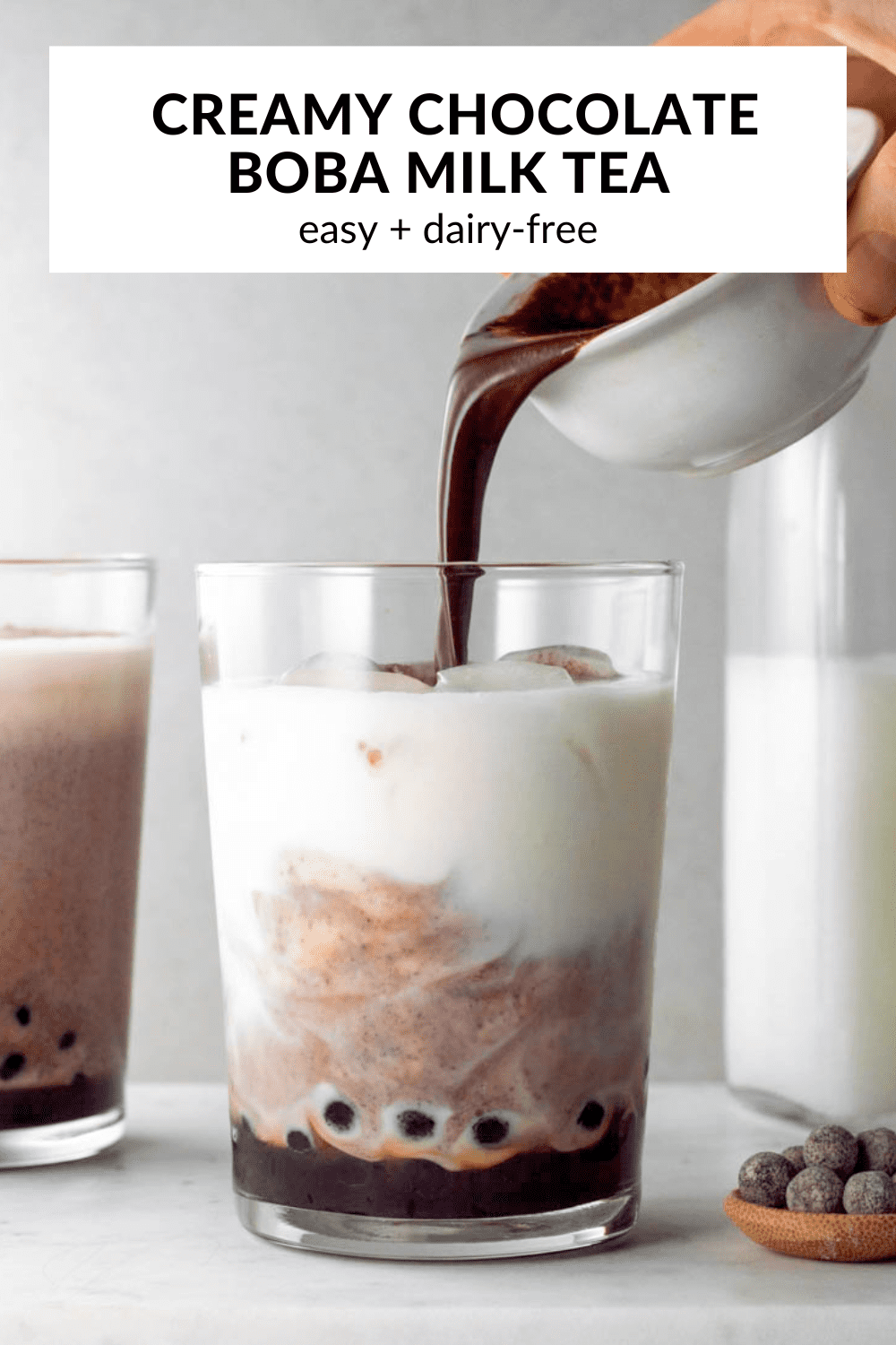A photo of chocolate boba with text overlay "Creamy chocolate boba milk tea".