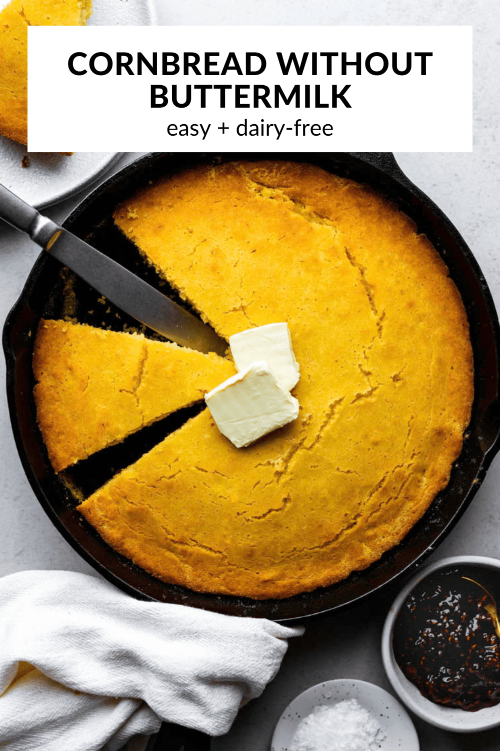 A photos of homemade cornbread in  cast iron skillet with text overlay "Easy cornbread without buttermilk".