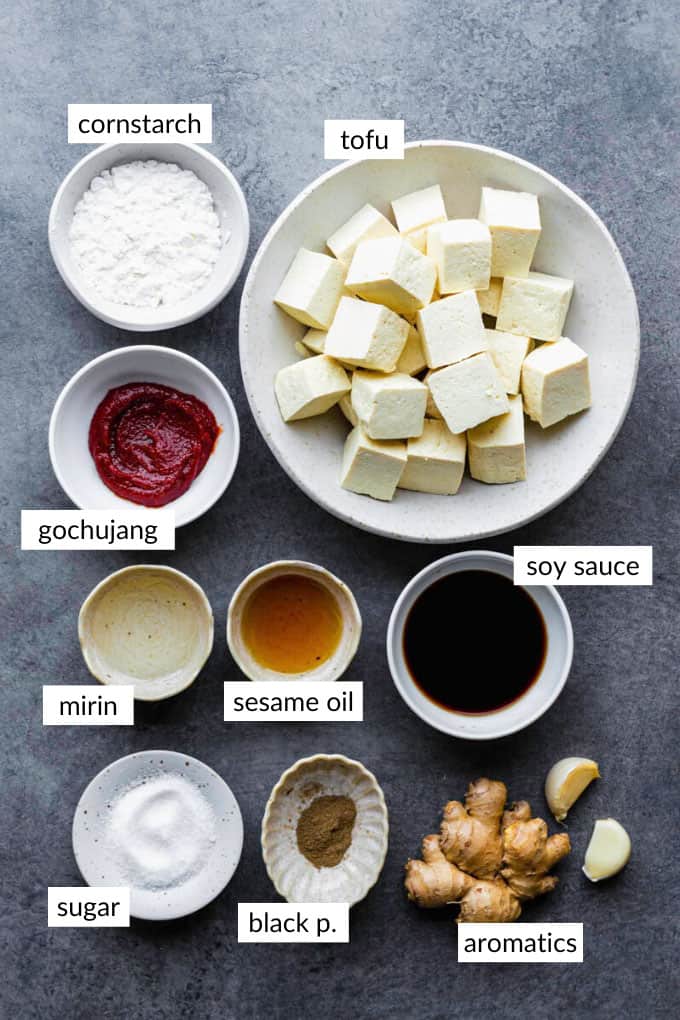 Gathered ingredients for making gochujang tofu with text overlay on each ingredient. 