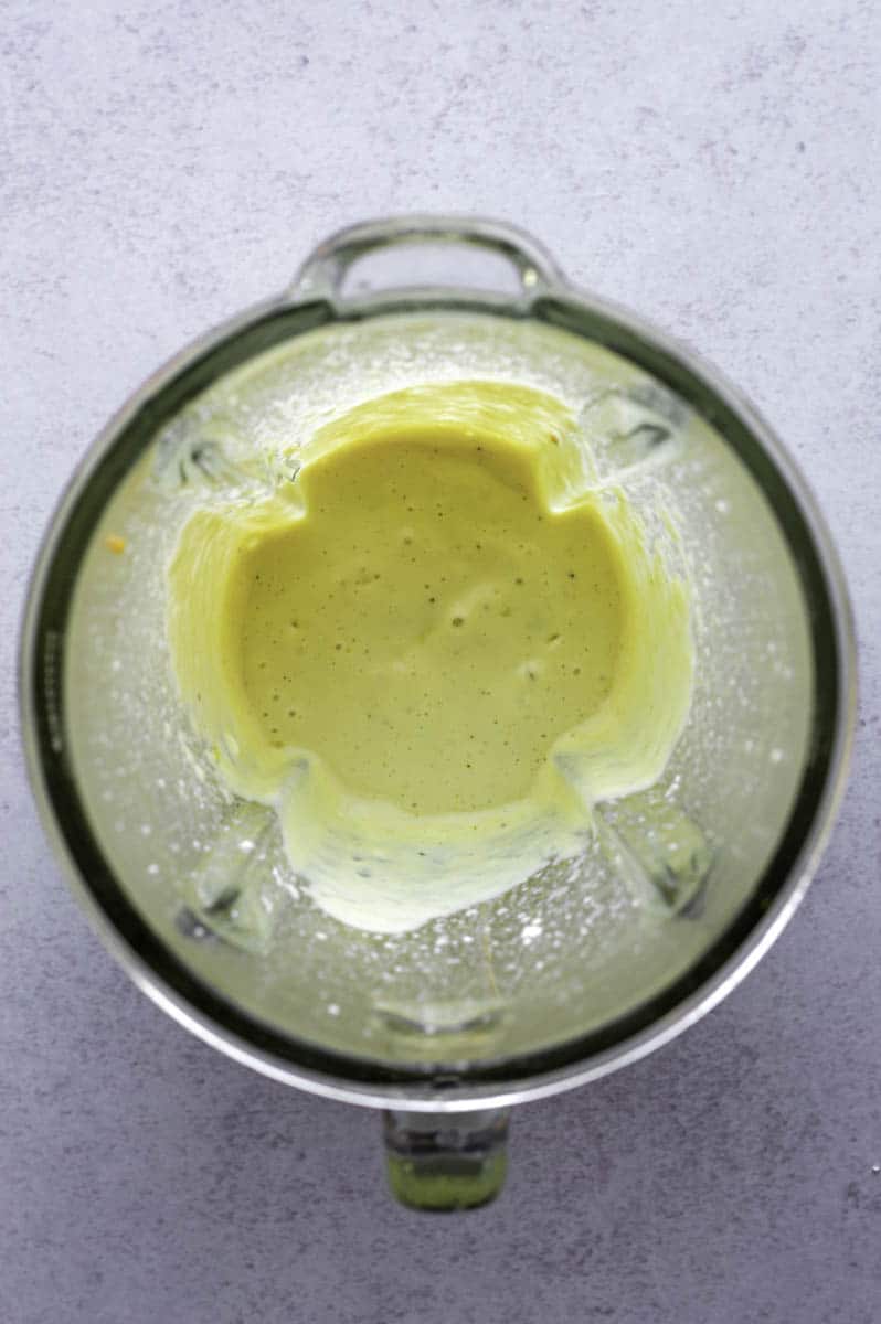 A smooth mixture of silken tofu, olive oil, water, and a bouillon cube in a blender.