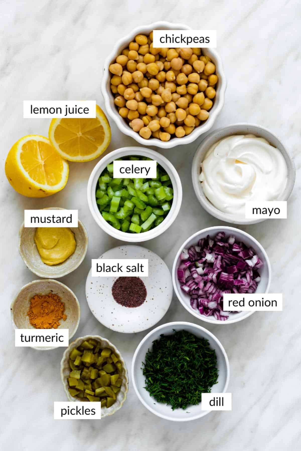Gathered ingredients for making chickpea egg salad with text overlay on each ingredient.