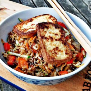 Warm Rice & Quinoa Salad with Pan Fried Tofu in a bowl with chopsticks.