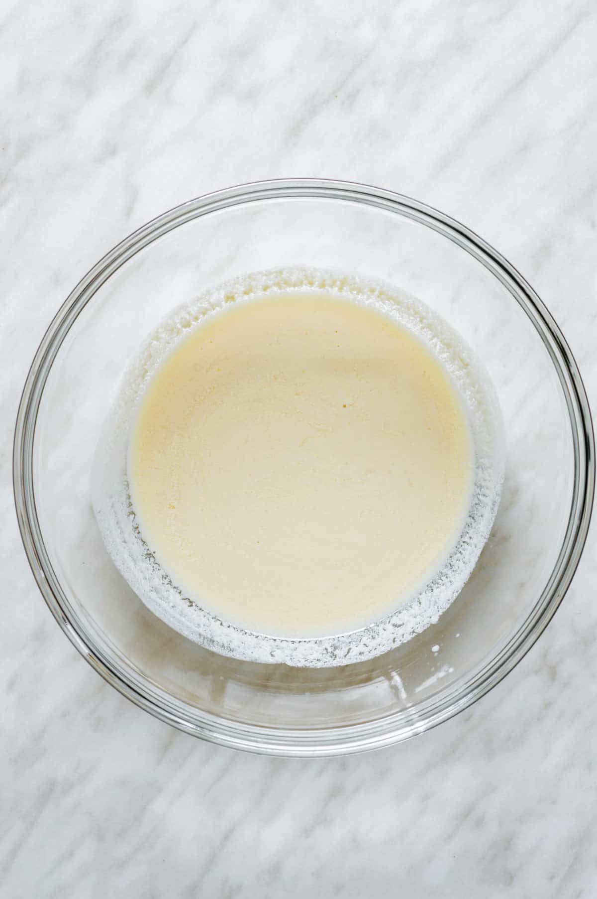 Vegan buttermilk in a glass mixing bowl.