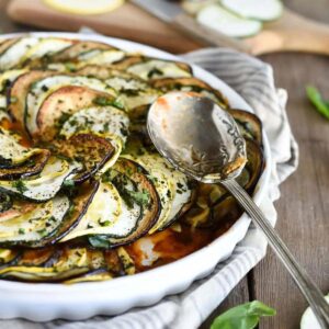 Roasted ratatouille in a white pie dish.
