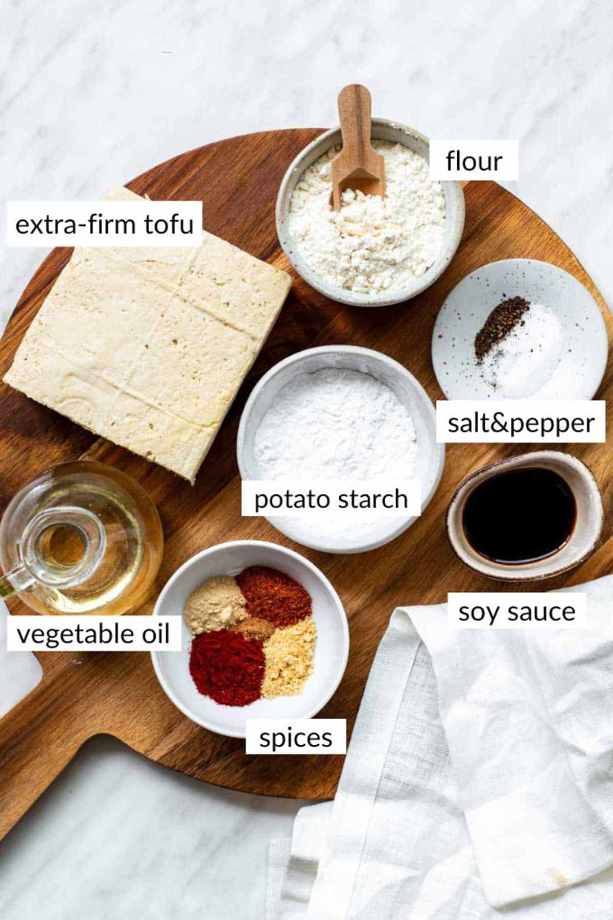 Gathered ingredients for making deep fried battered tofu with text overlay on each ingredient.