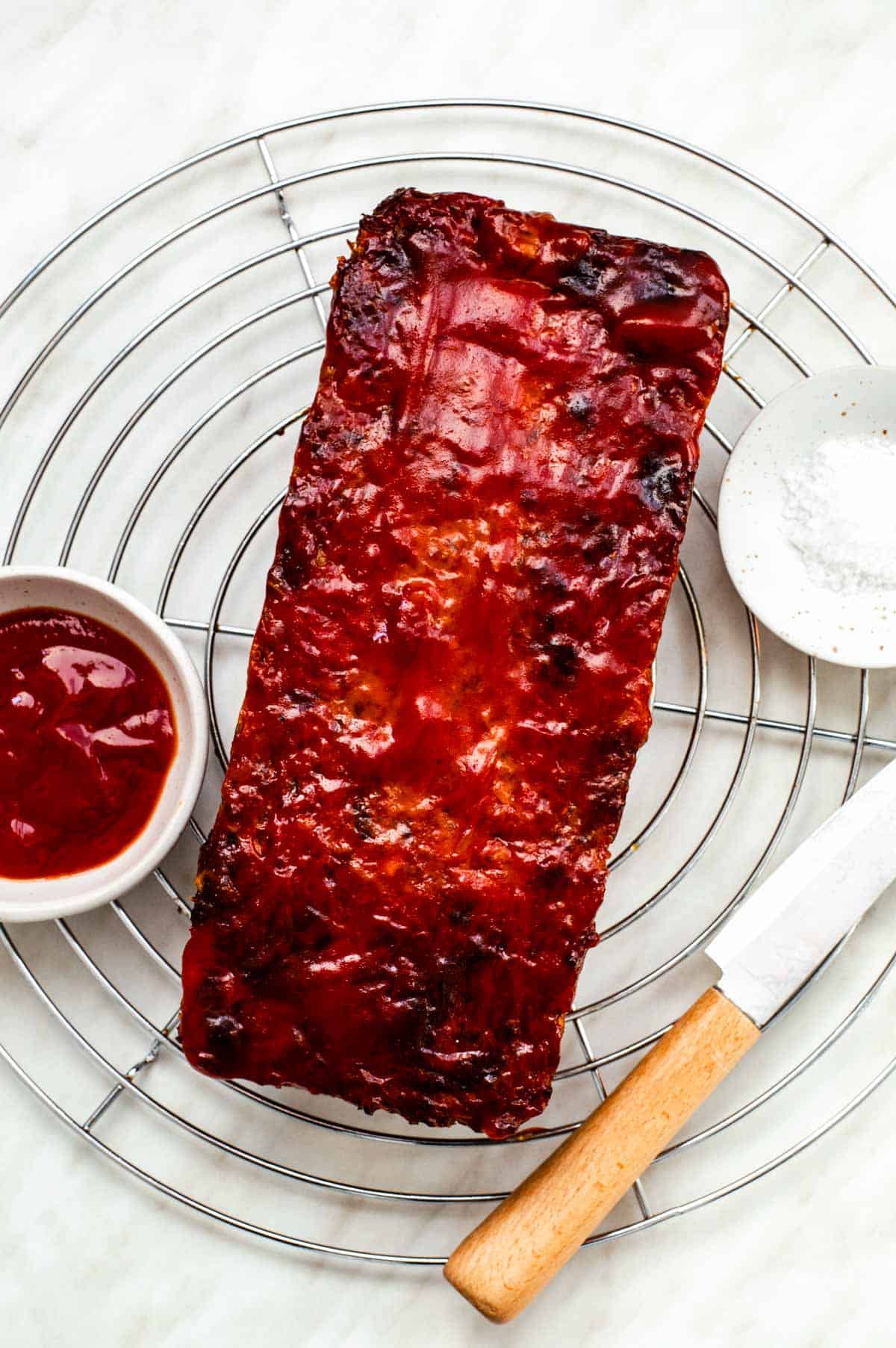 Beyond meatloaf resting on a cooling rack.