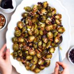 Roasted frozen Brussels sprouts served on a white plate.