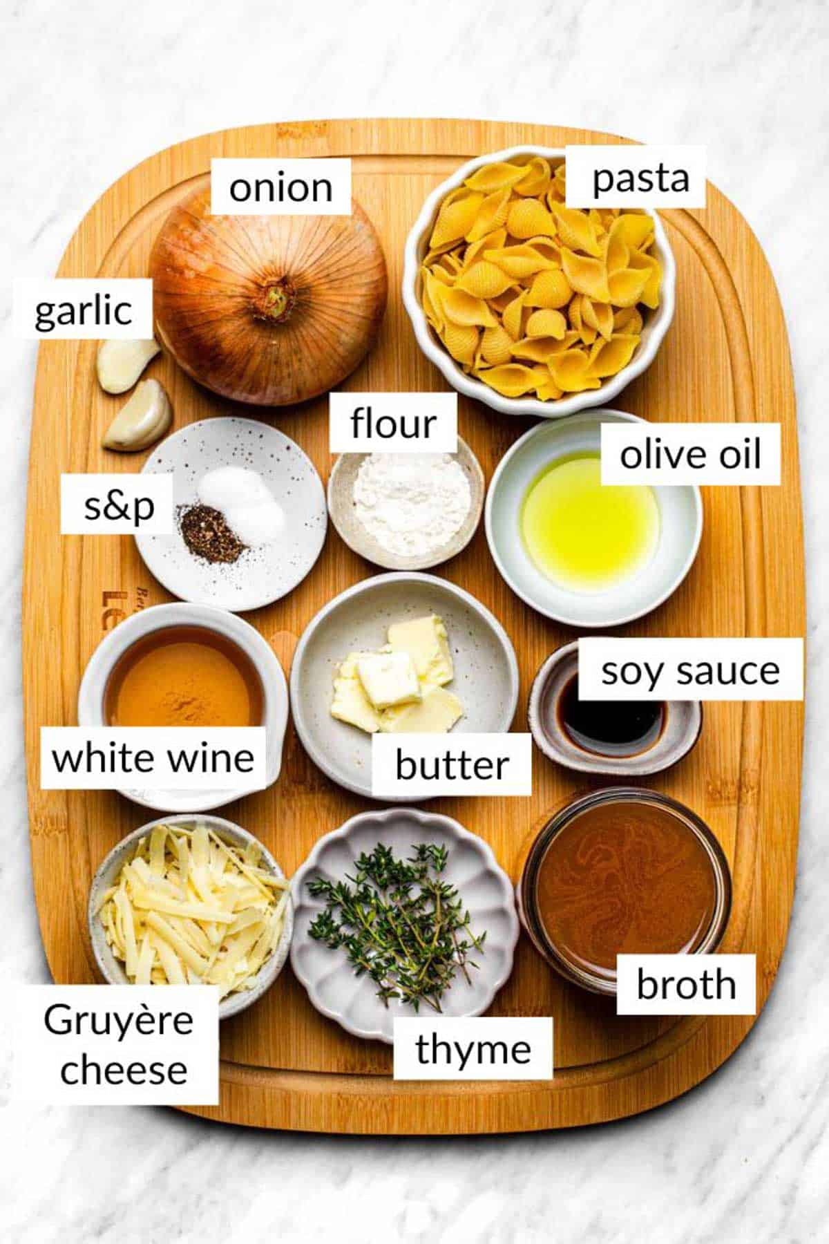 Gathered ingredients for making french onion pasta with text overlay on each ingredient..
