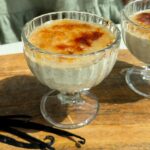 A glass cup filled with creme brulee overnight oats.