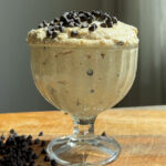 Cottage cheese cookie dough in an ice cream cup, topped with chocolate chips.