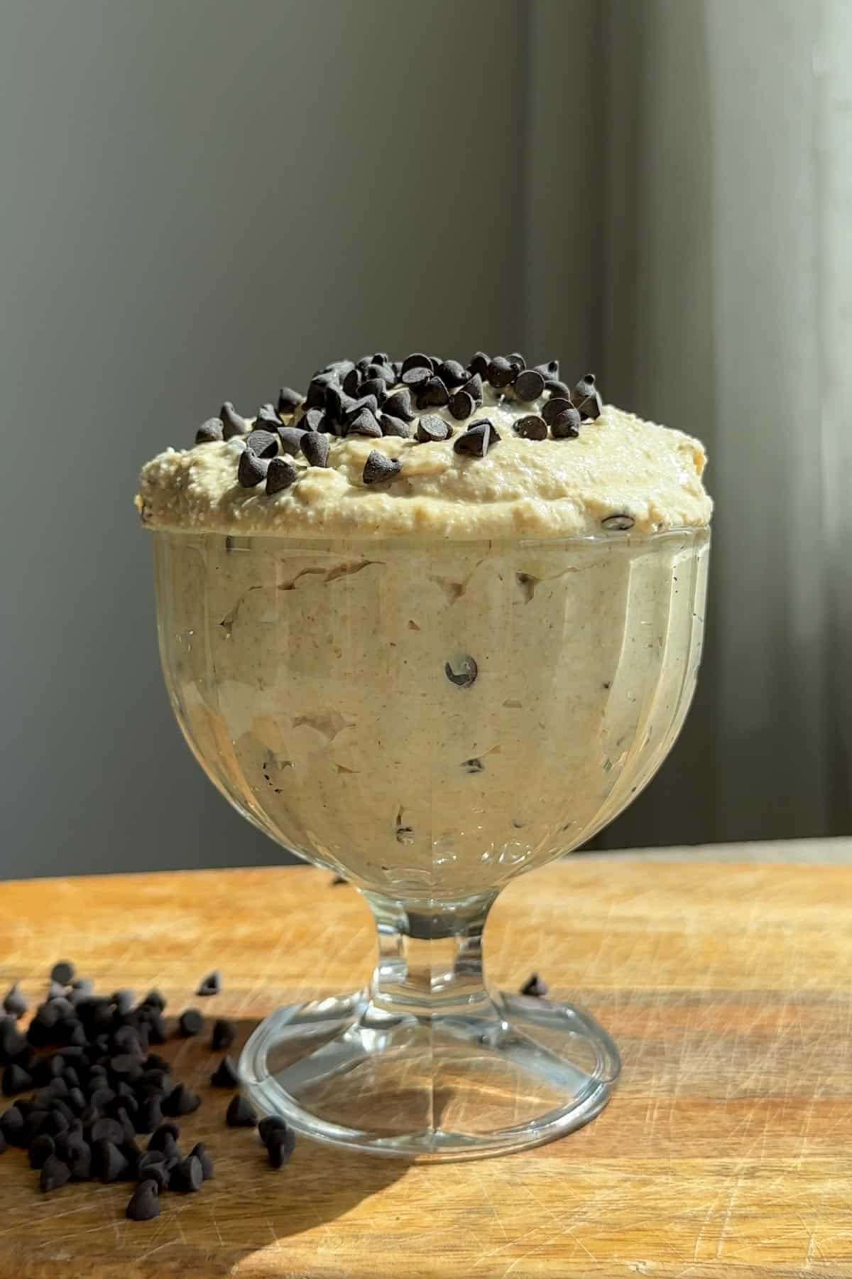 Cottage cheese cookie dough in an ice cream cup, topped with chocolate chips.