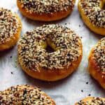 Bagels on a piece of parchment paper.