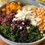 A blue bowl with kale, quinoa and roasted squash salad.