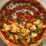 Butter bean stew topped with roasted cauliflower, cilantro and pomegranate seeds.