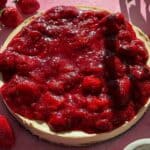 Vegan chickpea cheesecake topped with stewed strawberries.
