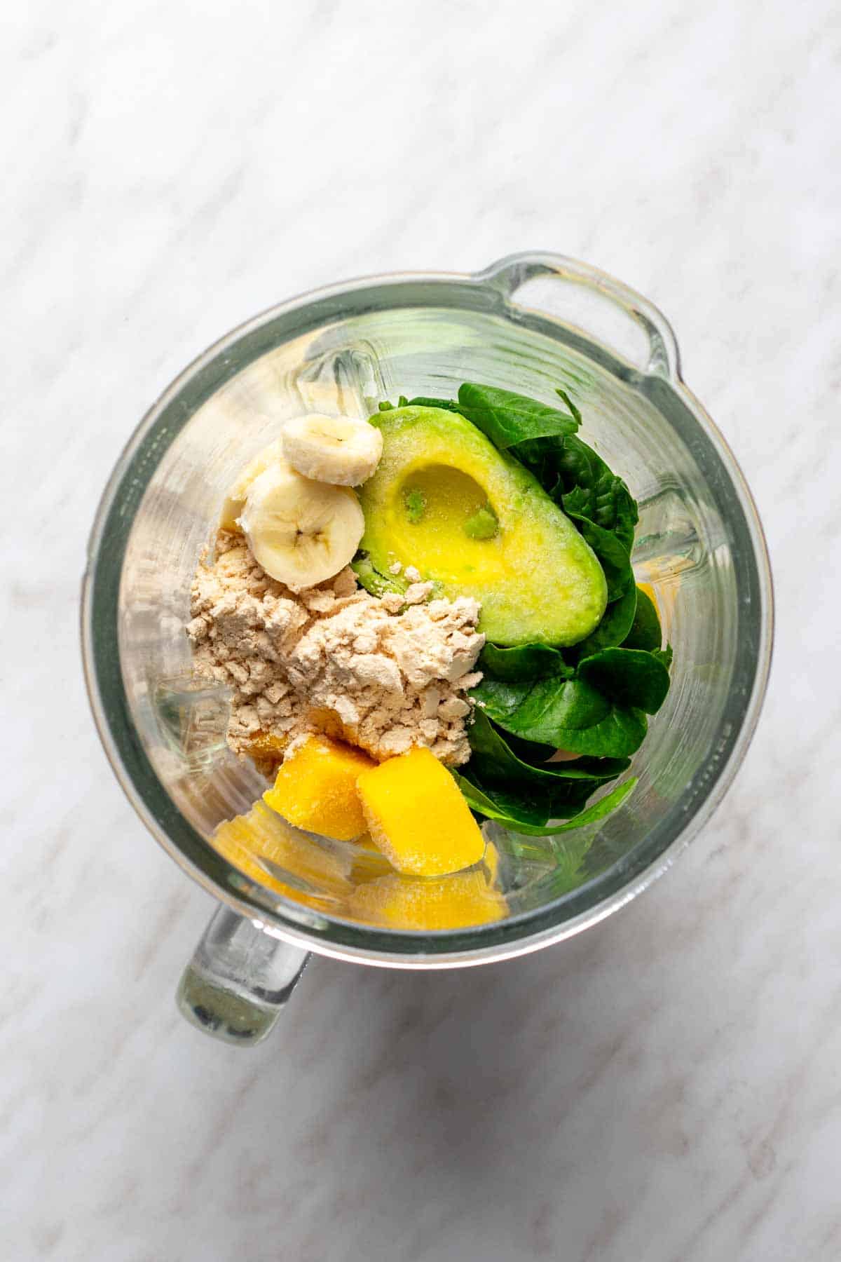 All the ingredients to make a smoothie in the blender. 