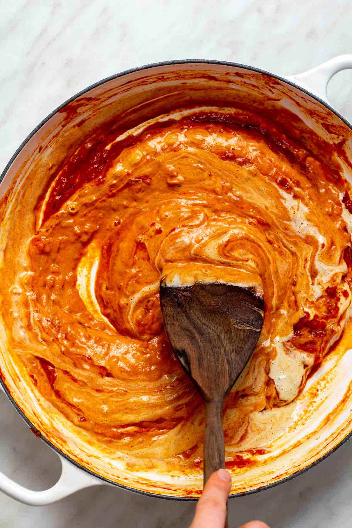 Stirring in the creamy component. 