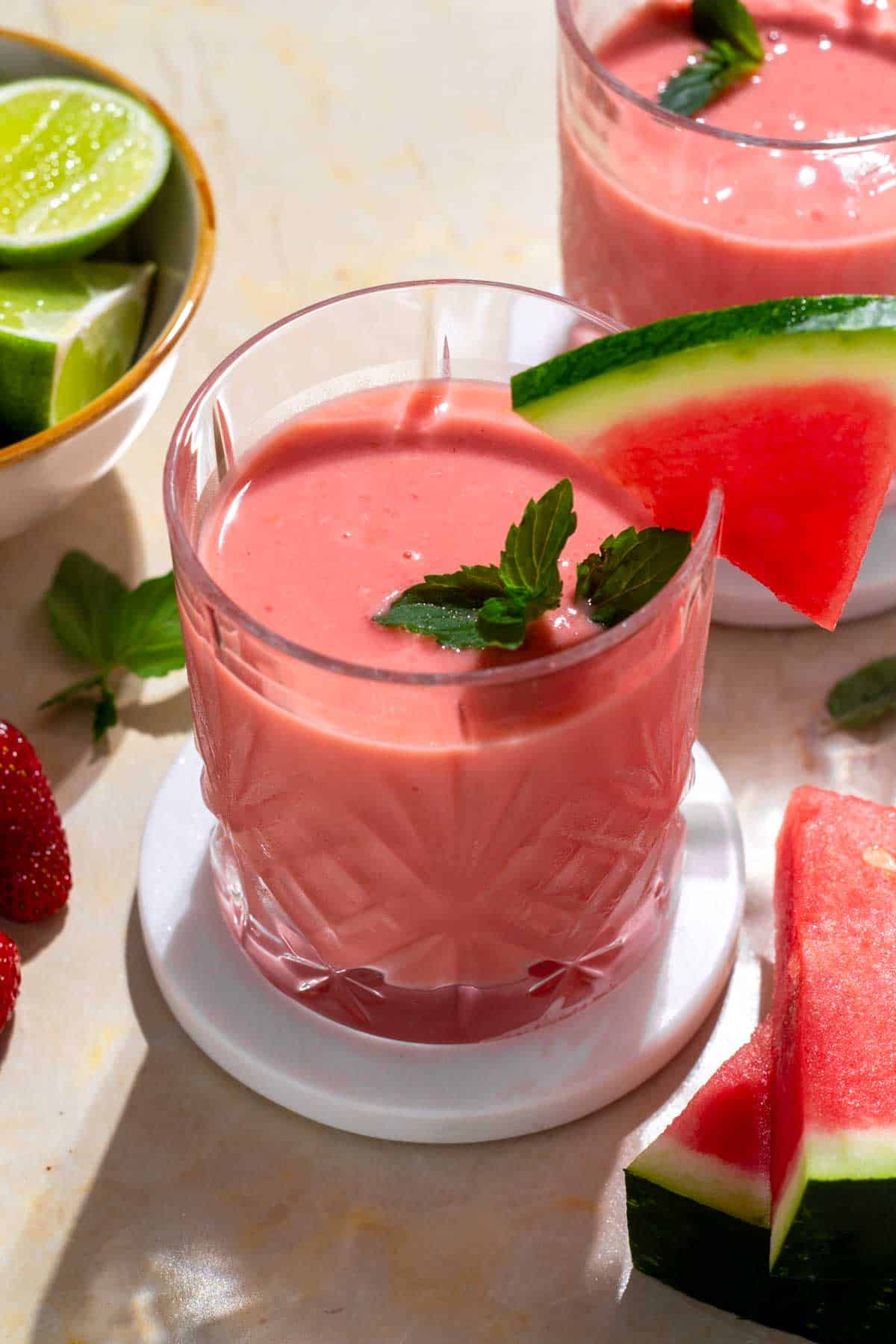 Mango watermelon smoothie with mint and watermelon garnish.